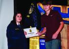 OHS FFA Reporter Valerie Hance presents FFA member Will Caffey with the Green Hand Degree. The Green Hand Degree is generally the first degree a new FFA member will earn after joining the FFA, signifying they have a good understanding of the history and p