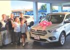 Karrie Canada and her children Jordyn Esquivel and Wacey Canada pick up their new vehicle after the community raised money to help Karrie get to cancer treatments in Wichita Falls. Photo courtesy of Chad Edgington