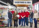 Olney Chamber of Commerce board members Jake Randall, Dan Branum, Chamber director Kimberly Smith, ACE owners Kris, Rand and Jeff Kamp, and Chamber board members Callie Hicks and board president Kaylah Hampton pose for a photo at Olney’s year-old ACE Ha