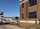 Construction crews repaired the sidewalk on the south side of the Olney Sub Courthouse last week to make way for a new access ramp and a child custody drop-off area with cameras. Photo by Gina Keating