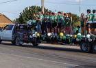 Bobcat football players and Varsity Cheerleaders wave to the crowded streets during the NHS HOCO Parade. | Photo by Will Sadler