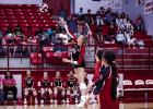 Lady Cub #20-Natalie Simmons sends a fiery shot over the net towards Lady Trojan defenders. Photo by Will Sadler