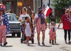 The Refuge Olney Christian Community Center director Rodney Nance, (far left) dressed as Uncle Sam, parades down Main Street with his family on July 4, after winning Most Patriotic Citizen for the third year in a row. Photo by Will Sadler