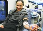 Olney resdient Randee Schnur smiles for a photo while donating blood for the Olney High School Blood Drive Friday outside the OHS gym.