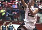 Olney High School senior forward Travis Hudson puts in a layup during the first half of a game against Santos.