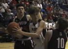 Olney High School senior guard Brent McCorkle fights of Seymour's aggressive defenders.