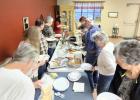 Director Angela Lockard will lobby for state funds for the Olney Senior Cub Center this month in Austin to ensure that programs such as Meals on Wheels and feeding programs are funded. Above, Thursday game night attendees line up for a pot luck. Photo by Will Sadl