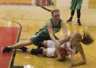 Above: Newcastle sophomore guard Arryn Eli and Olney senior guard Niki Wade fight for possession during Tuesday’s season opener. Newcastle won 55-37.