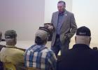 House District 68 State Rep. Drew Springer visits with a group of Olney citizens inside the Olney Civic Center while touring the area Monday afternoon.