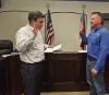 Olney City Attorney Dan Branum swears in Olney’s new city administrator, Andy Wolfe at the June 8 City Council meeting. Mr. Wolfe starts at his new post about nine months after the departure of former city administrator Simon Dwyer. Photo by Dale Lovett