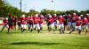 The Cubs Offensive line is confident this season, with a seasoned running back in Kyle Stewart. Cubs warming up before their scrimmage with the Eagles. Photo by Will Sadler